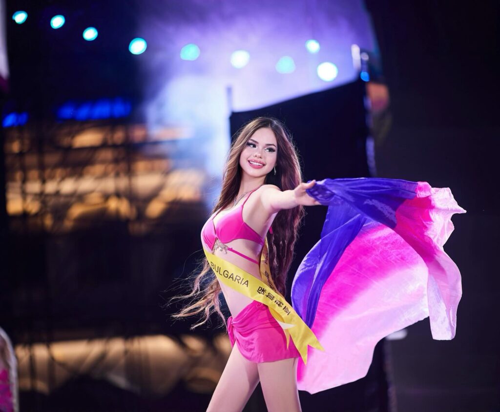 Sara Bakalova, Miss Multiverse Bulgaria 2025, standing outdoors in Sofia wearing a pink dress, representing Bulgaria’s new generation of educated, eco-conscious beauty leaders and future founder of a sustainable bio-beauty brand.